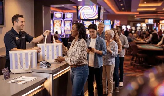 Guest picking up a continuity tote gift at the redemption counter